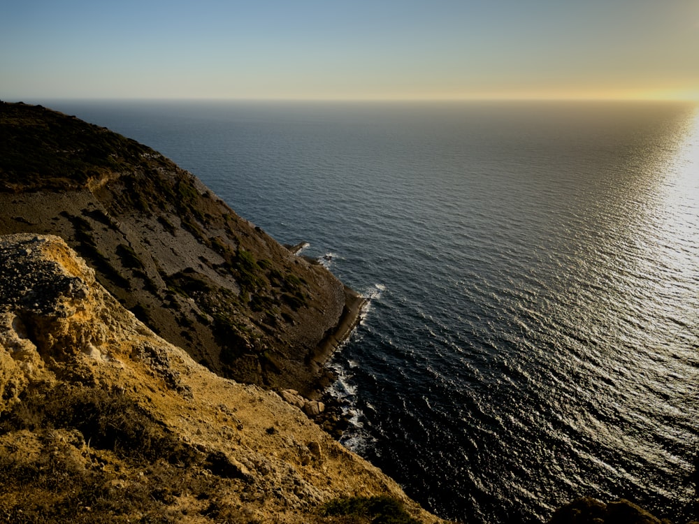 a view of the ocean from the top of a hill