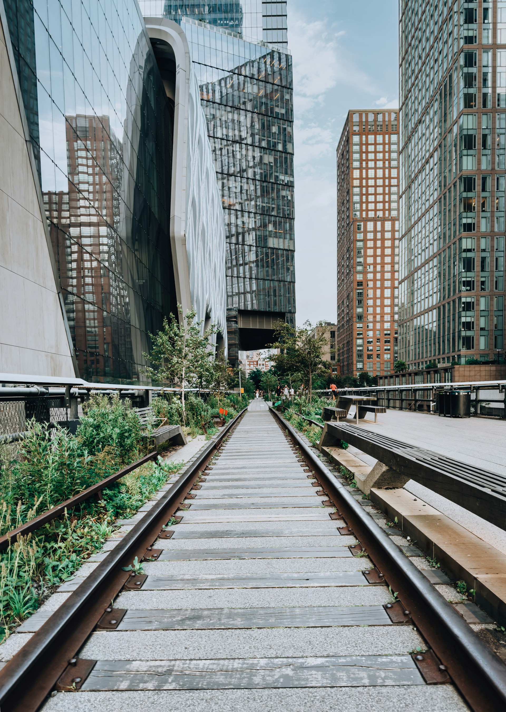 a set of train tracks in front of tall buildings