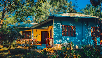 Brightly painted house exterior bathed in sunlight with fresh blue paint