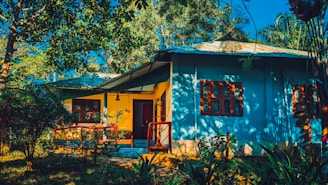 Wide shot of a freshly painted house with vibrant colors under bright sunlight.