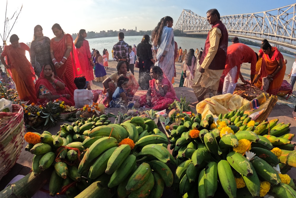 a group of people standing around a bunch of bananas