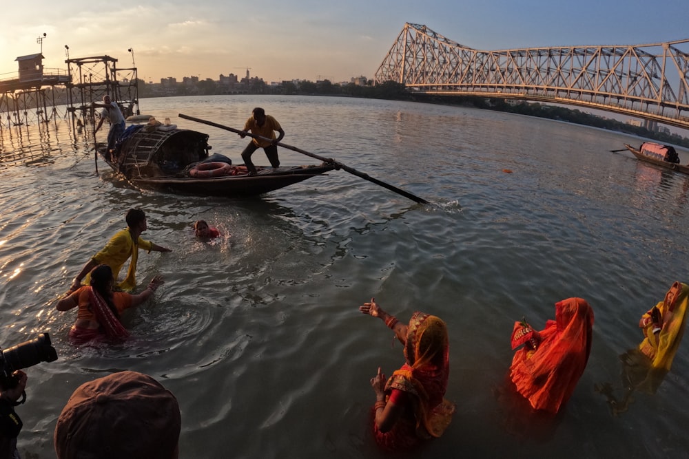 a group of people in saris in the water