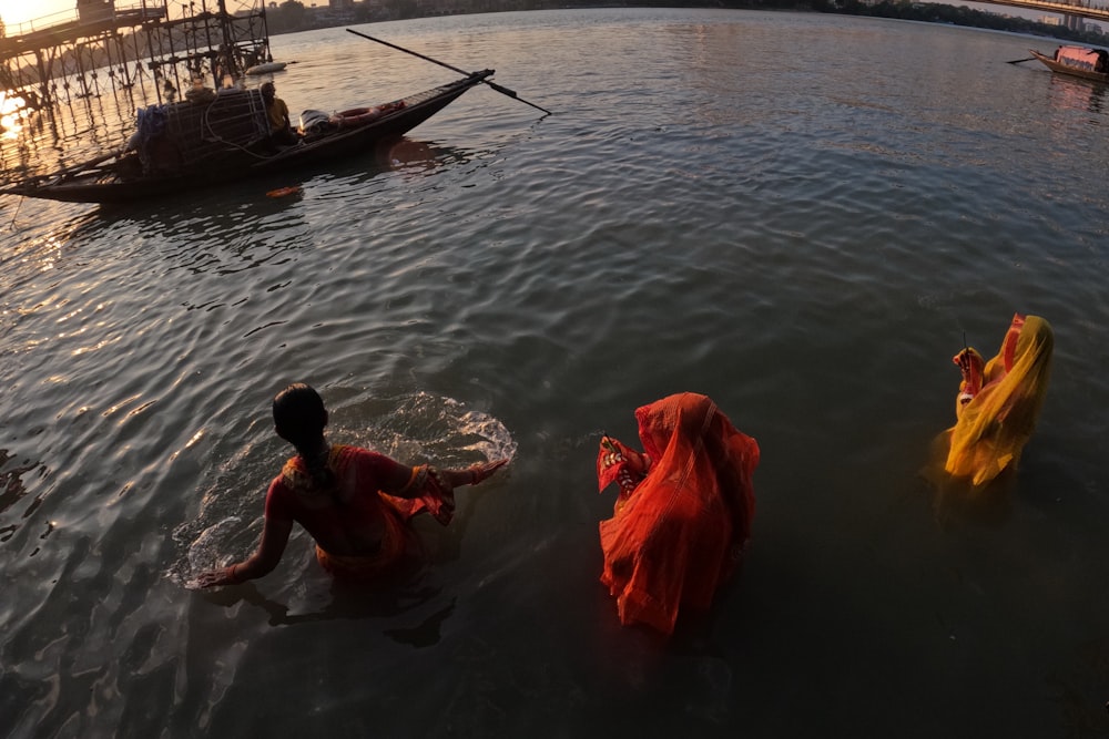 two women in sari bathing in a river