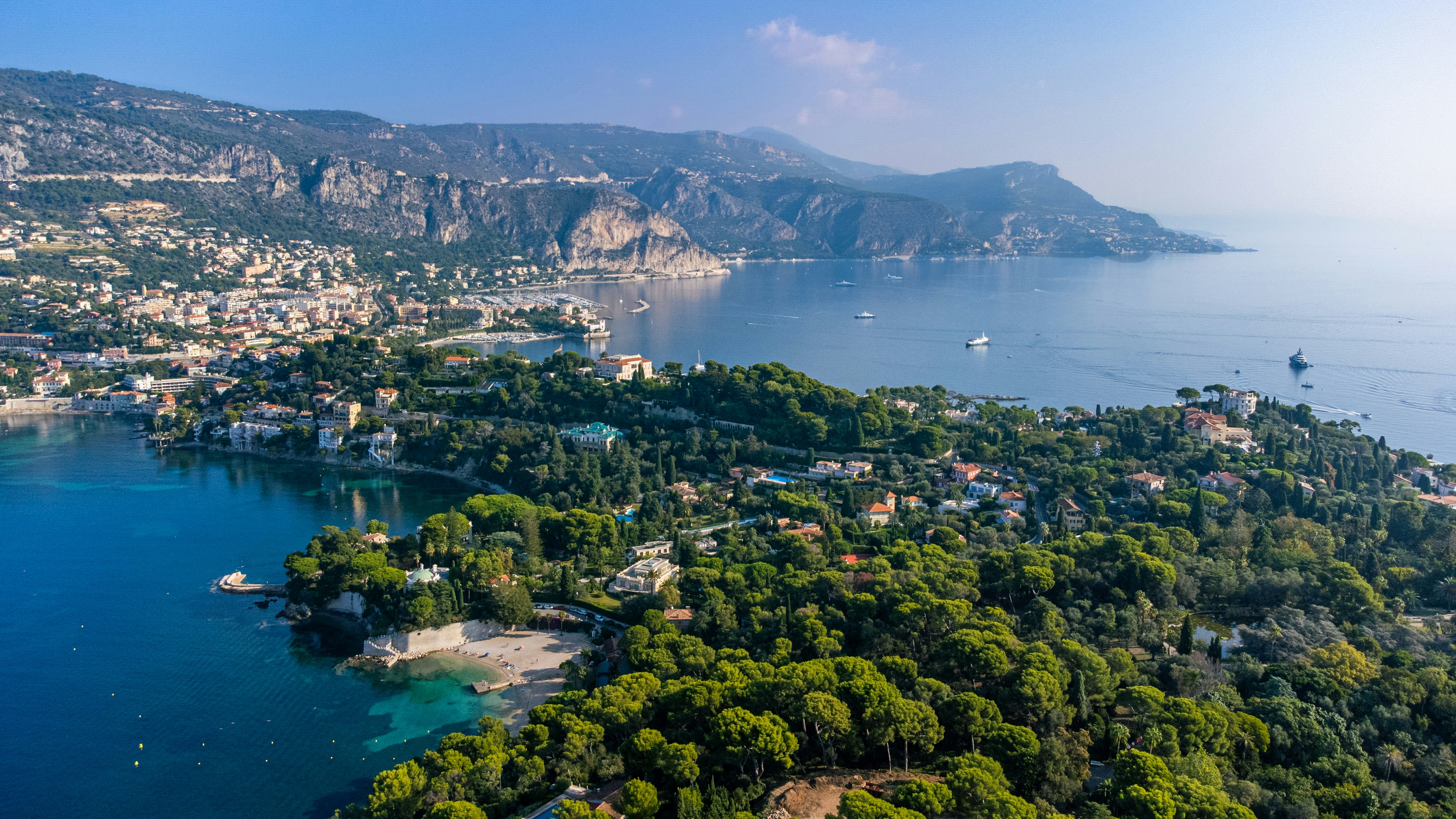an aerial view of a small town on the shore of a lake
