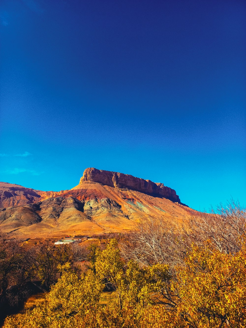 a mountain with a blue sky in the background