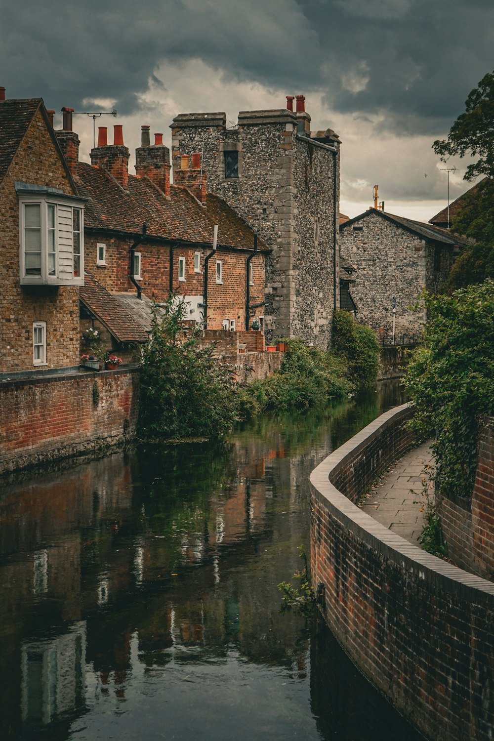 a river running through a city next to tall buildings