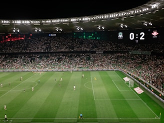 A vibrant digital scoreboard showing live soccer match scores and user predictions.