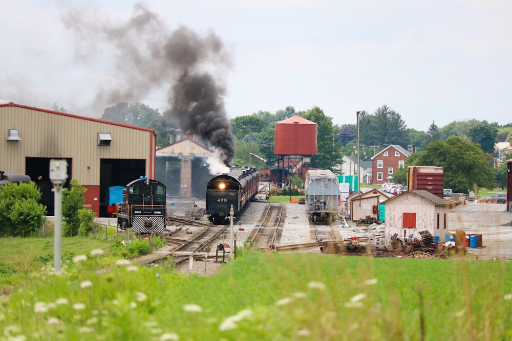 a train traveling down train tracks next to a building