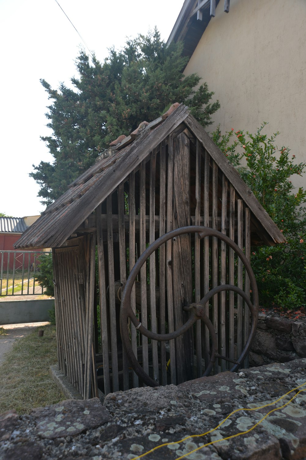 a wooden structure with a wheel attached to it