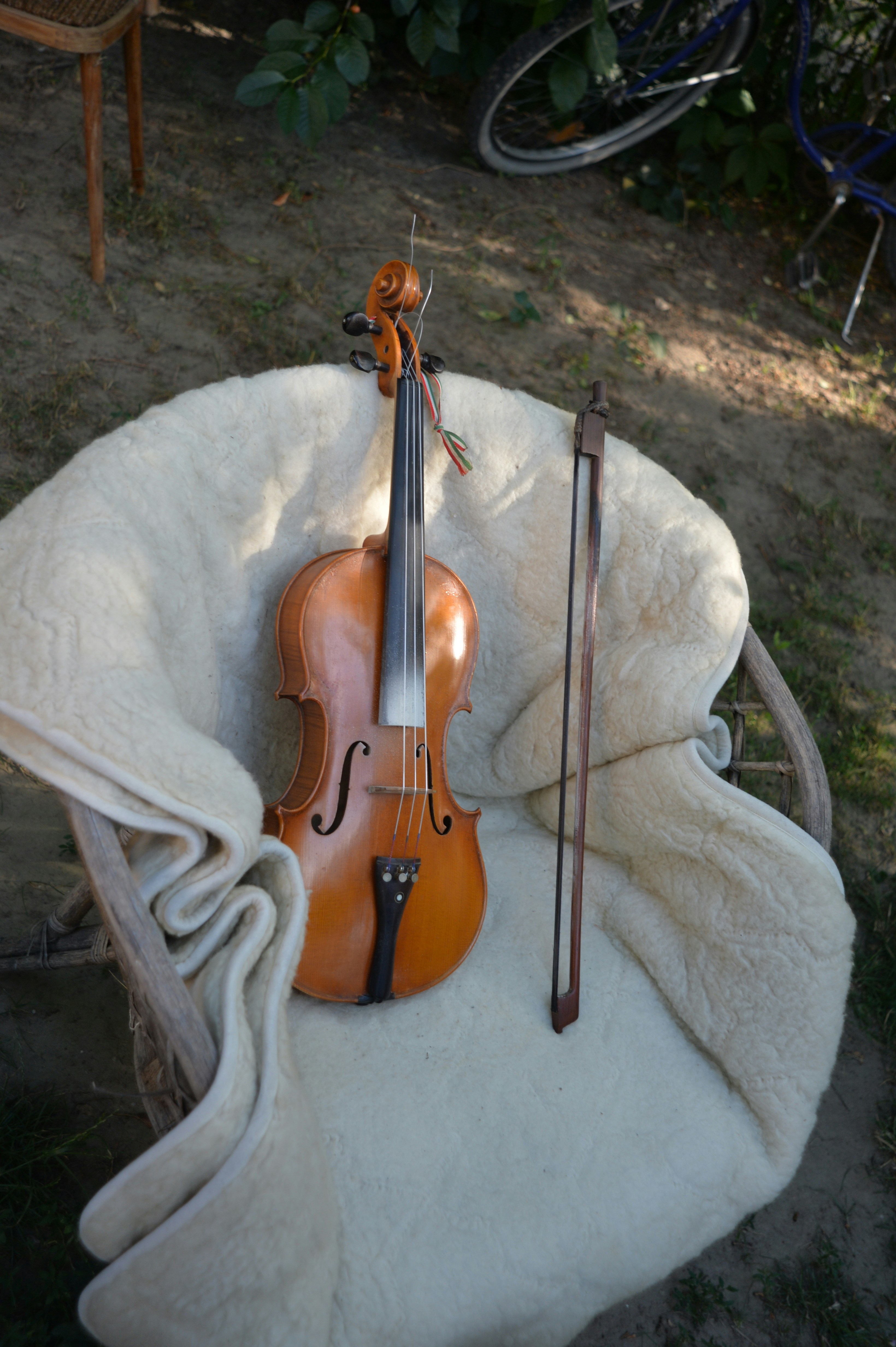a violin sitting on top of a white blanket