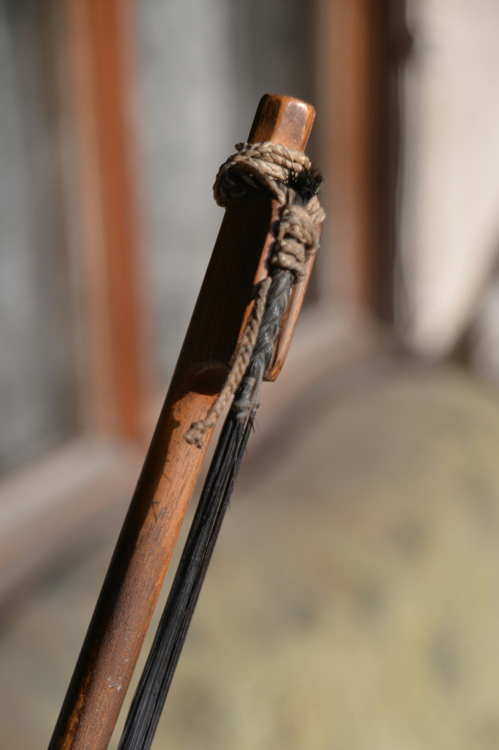 a close up of a wooden stick with a rope on it