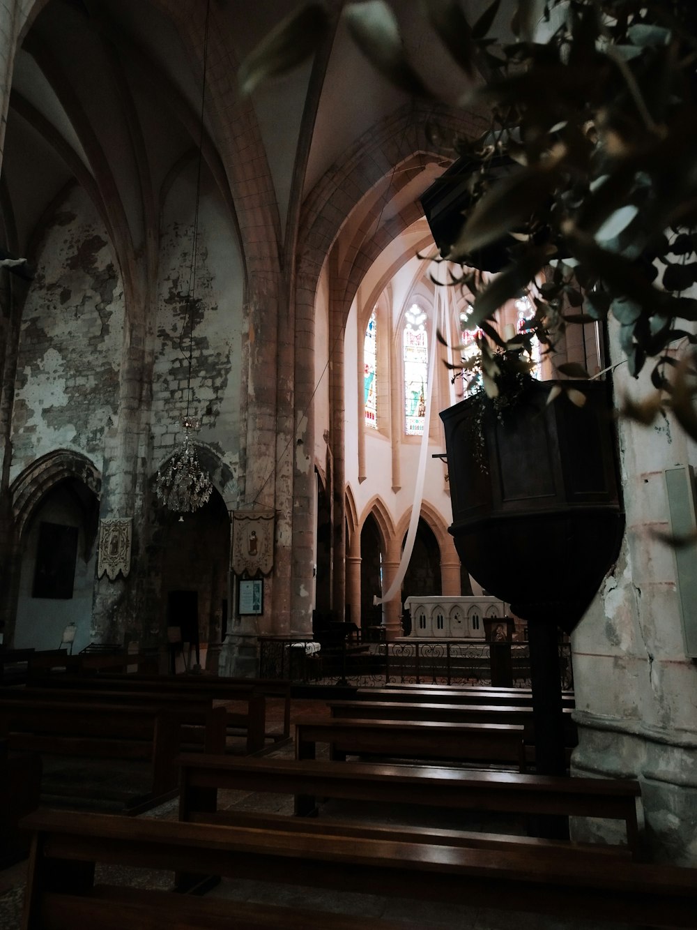 an old church with pews and stained glass windows