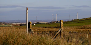 Technician installing anti-intrusion sensors on a farm gate