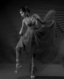 A fragile lace dress caught mid-twirl, capturing stillness and delicate beauty.