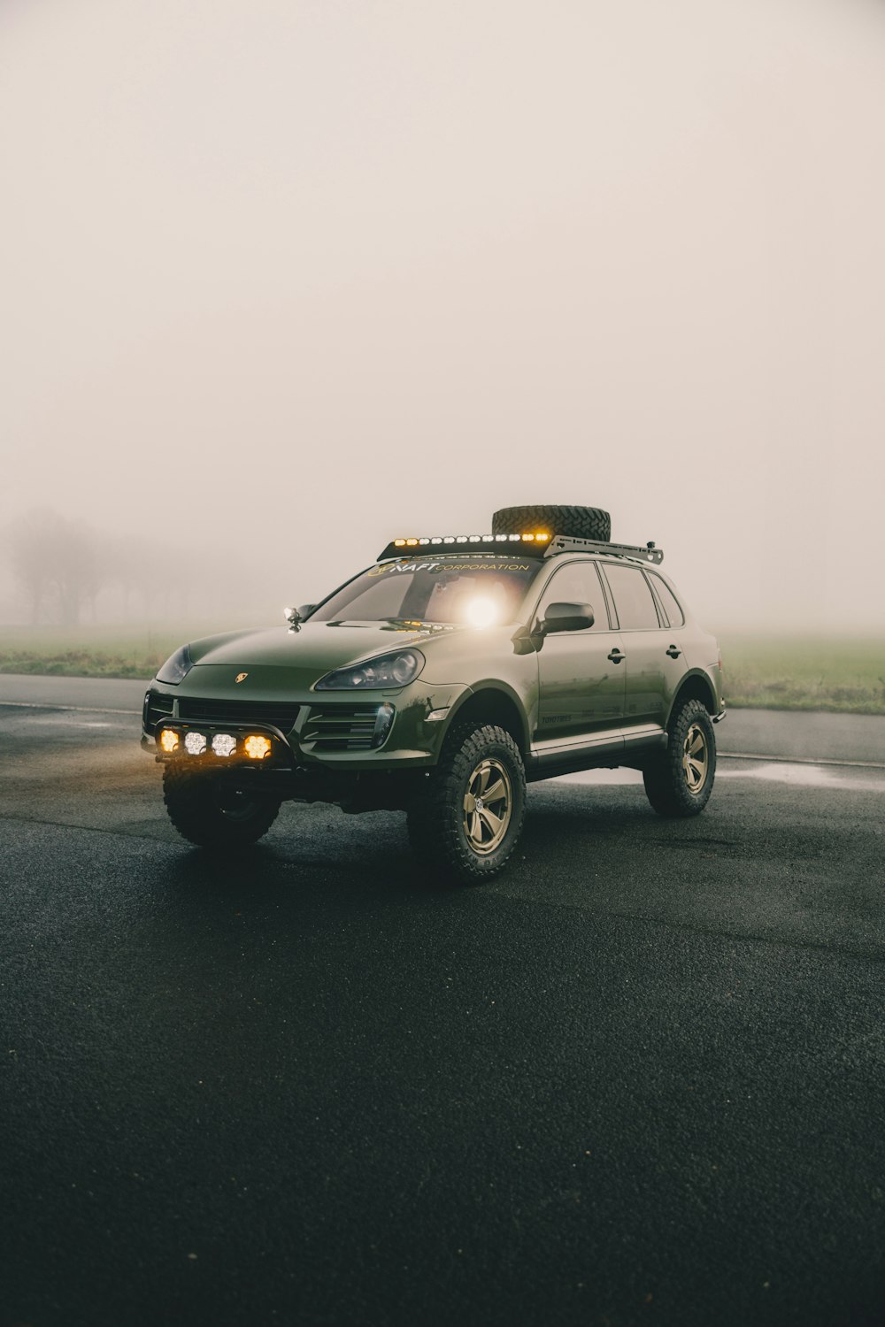 a truck with lights on driving down a road