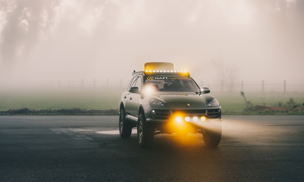 a car driving down a road with fog in the background