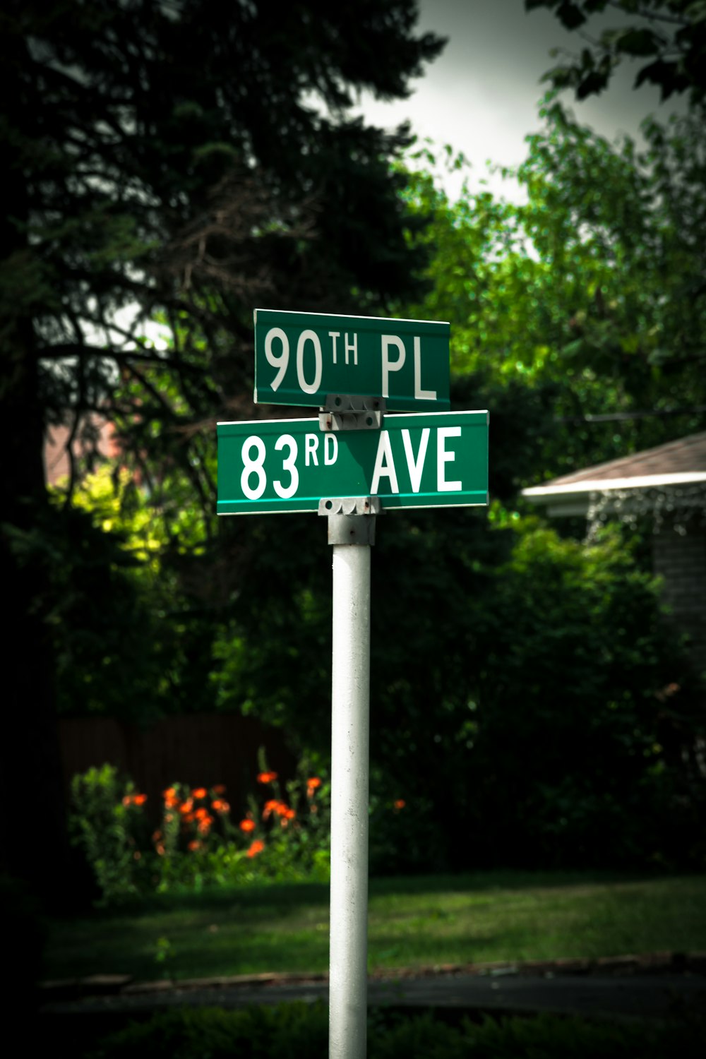 a green street sign sitting on the side of a road