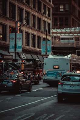 A transport vehicle navigating a busy city street during rush hour.