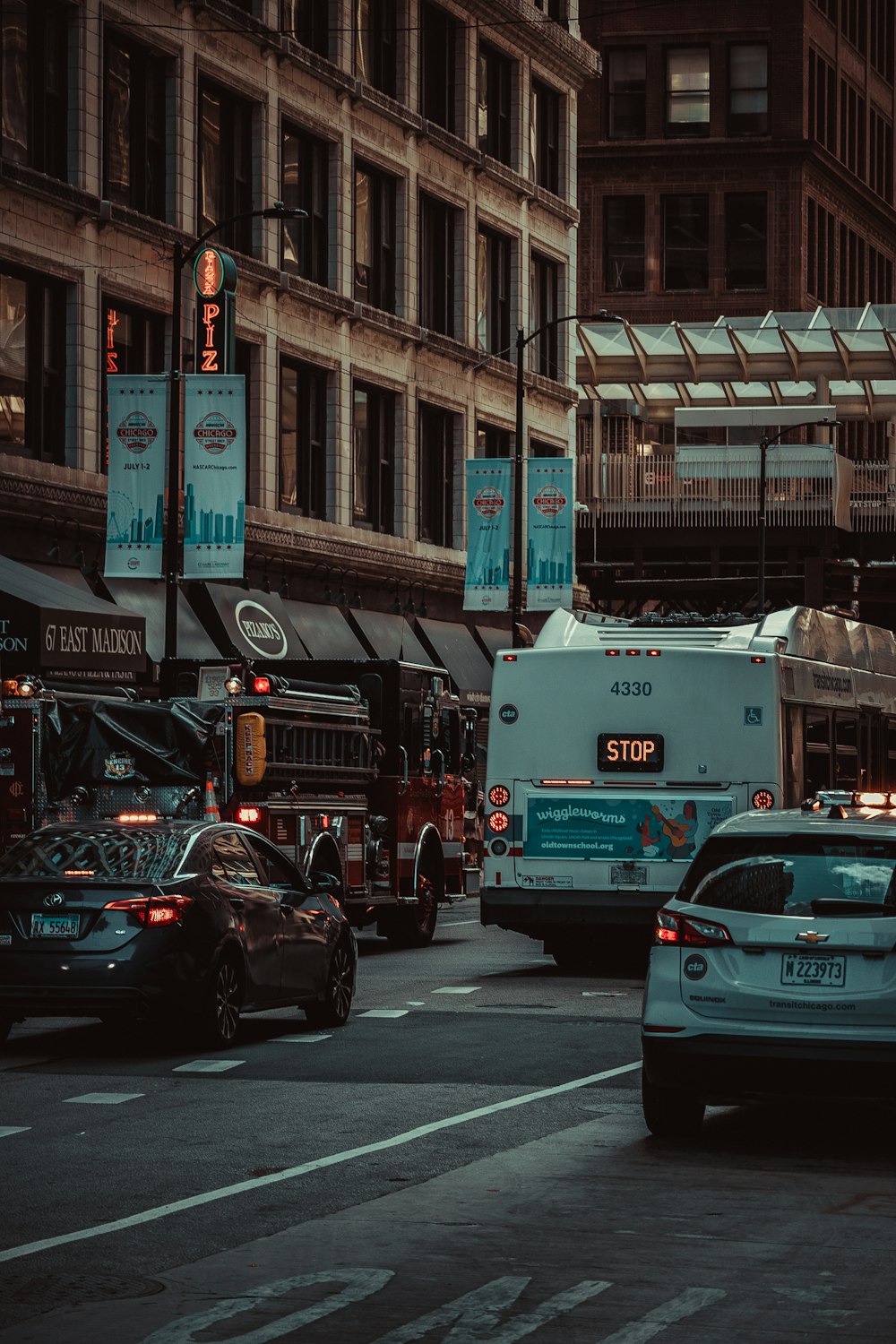 a city street filled with traffic next to tall buildings