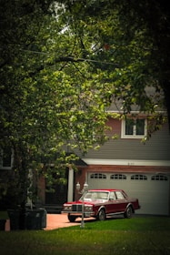 Jill’s bright red driving school car parked near a quiet suburban street.