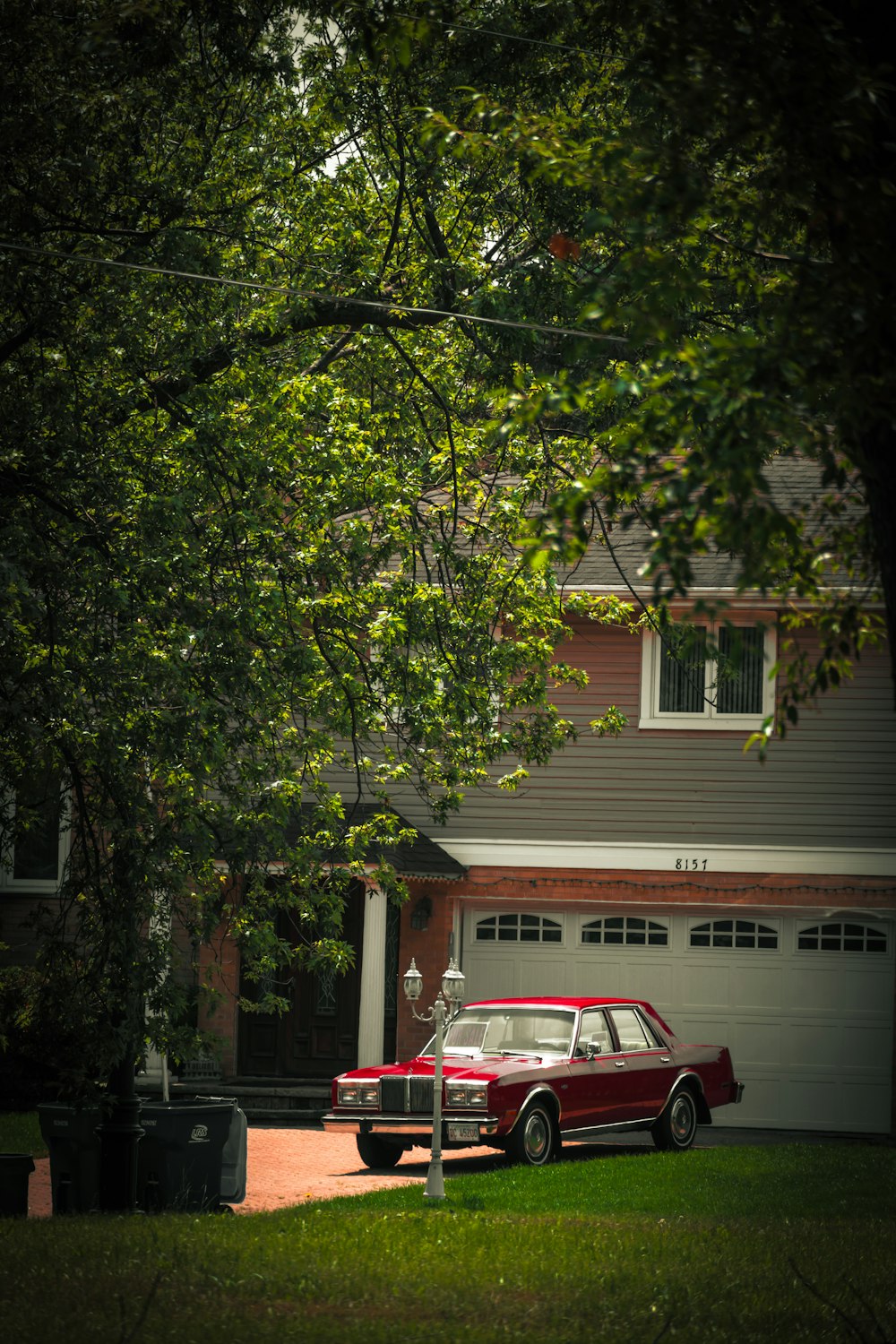 a red car parked in front of a house