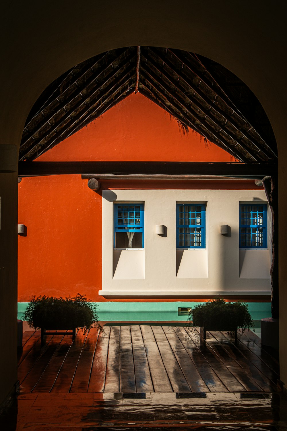 an orange and white house with a blue window