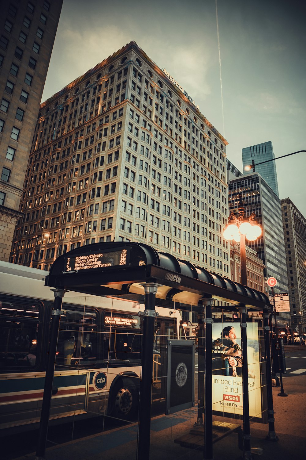 a bus is parked in front of a tall building