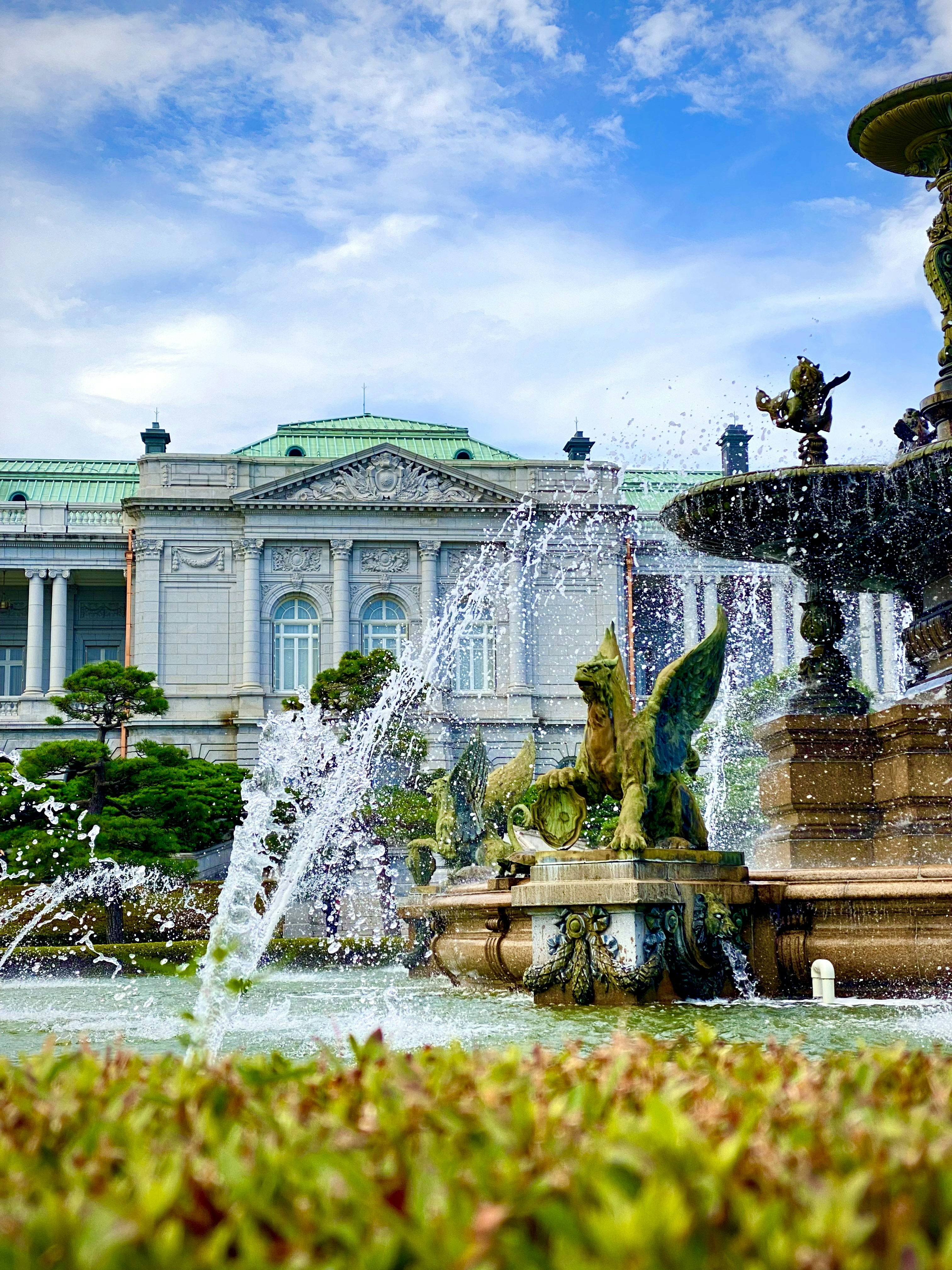 a water fountain in front of a large building