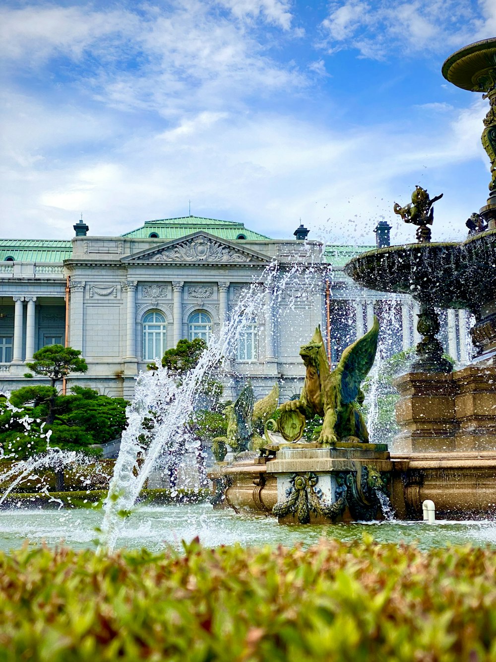 a water fountain in front of a large building