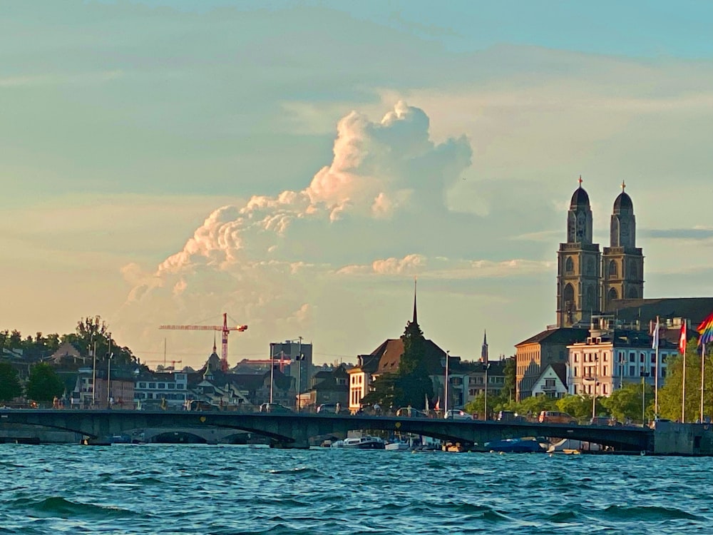 a large body of water with buildings in the background