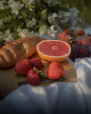 A cozy picnic setup with fresh bread and morning light on a camping table.