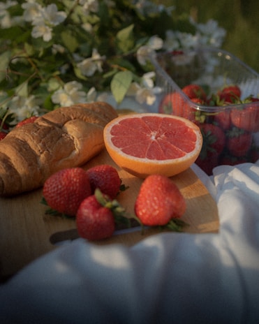 A cozy picnic setup with fresh bread and morning light on a camping table.