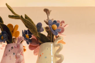 a couple of vases that have flowers in them