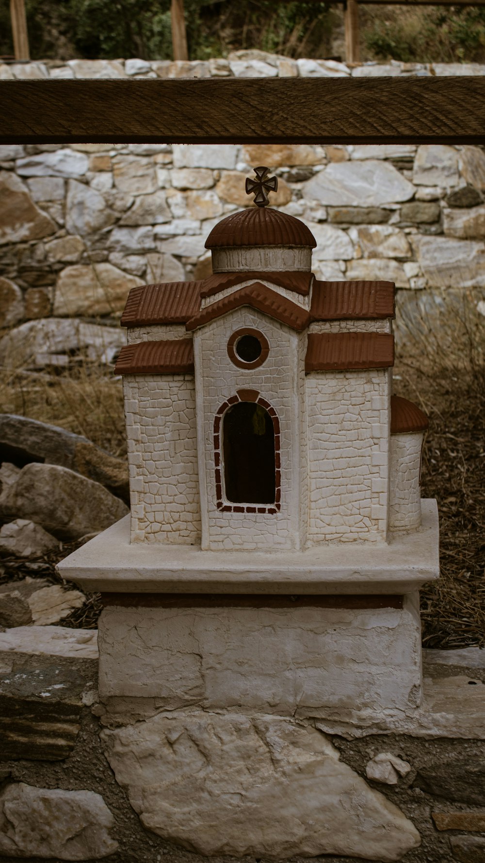 a small white building with a brown roof