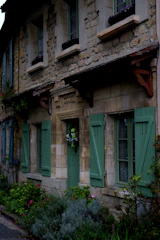 Exterior view of a renovated traditional Saint-Malo stone house with fresh paint and new windows