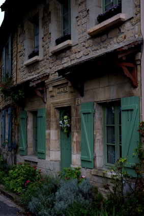 Cozy village house with stone walls and wooden shutters in a quiet Ariège village.