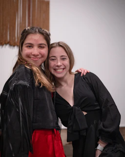 two girls are posing for a picture together