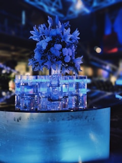 Close-up of a beautifully decorated table featuring golden accents and electric blue floral arrangements.