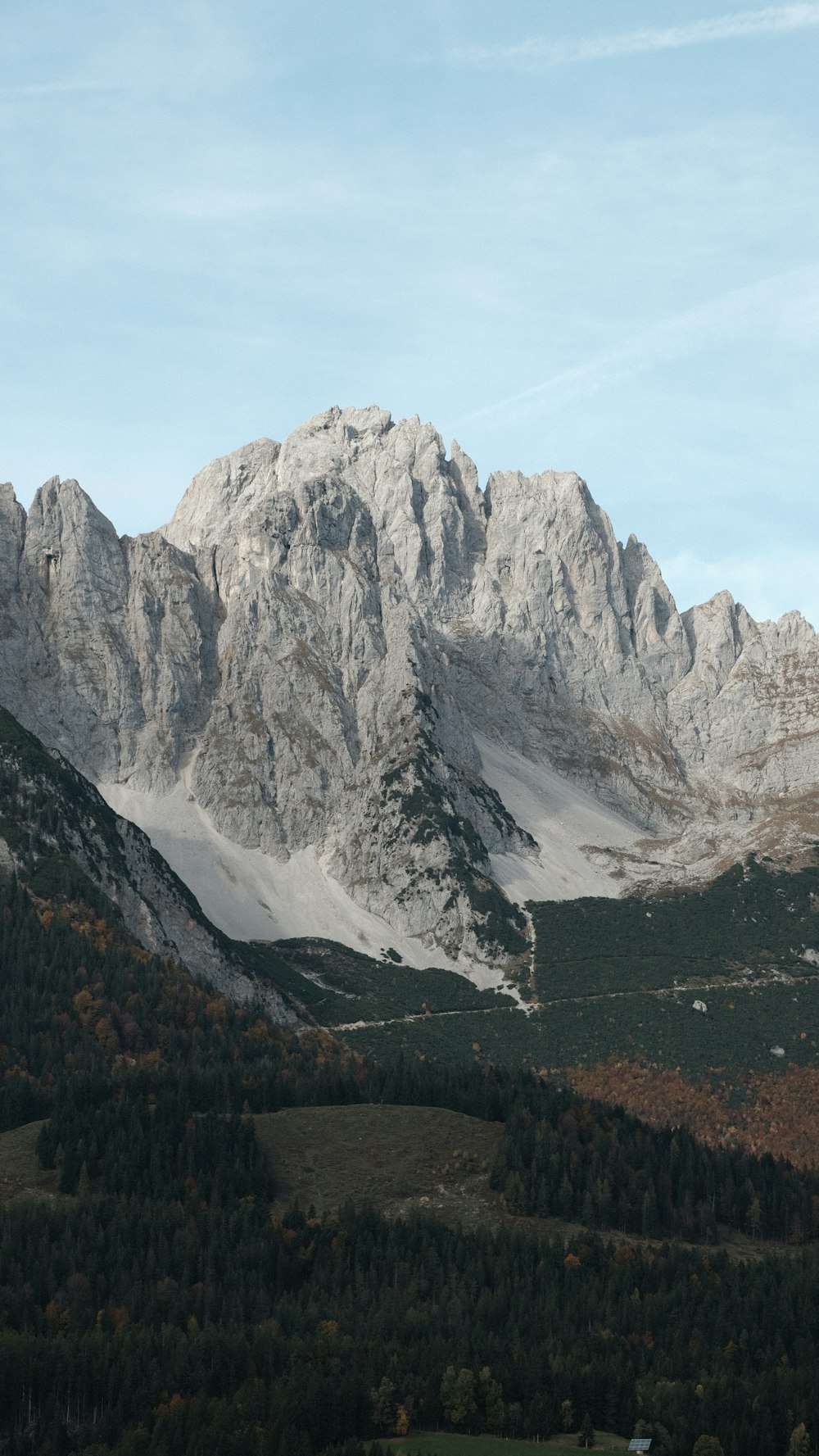 a view of a mountain range with trees in the foreground