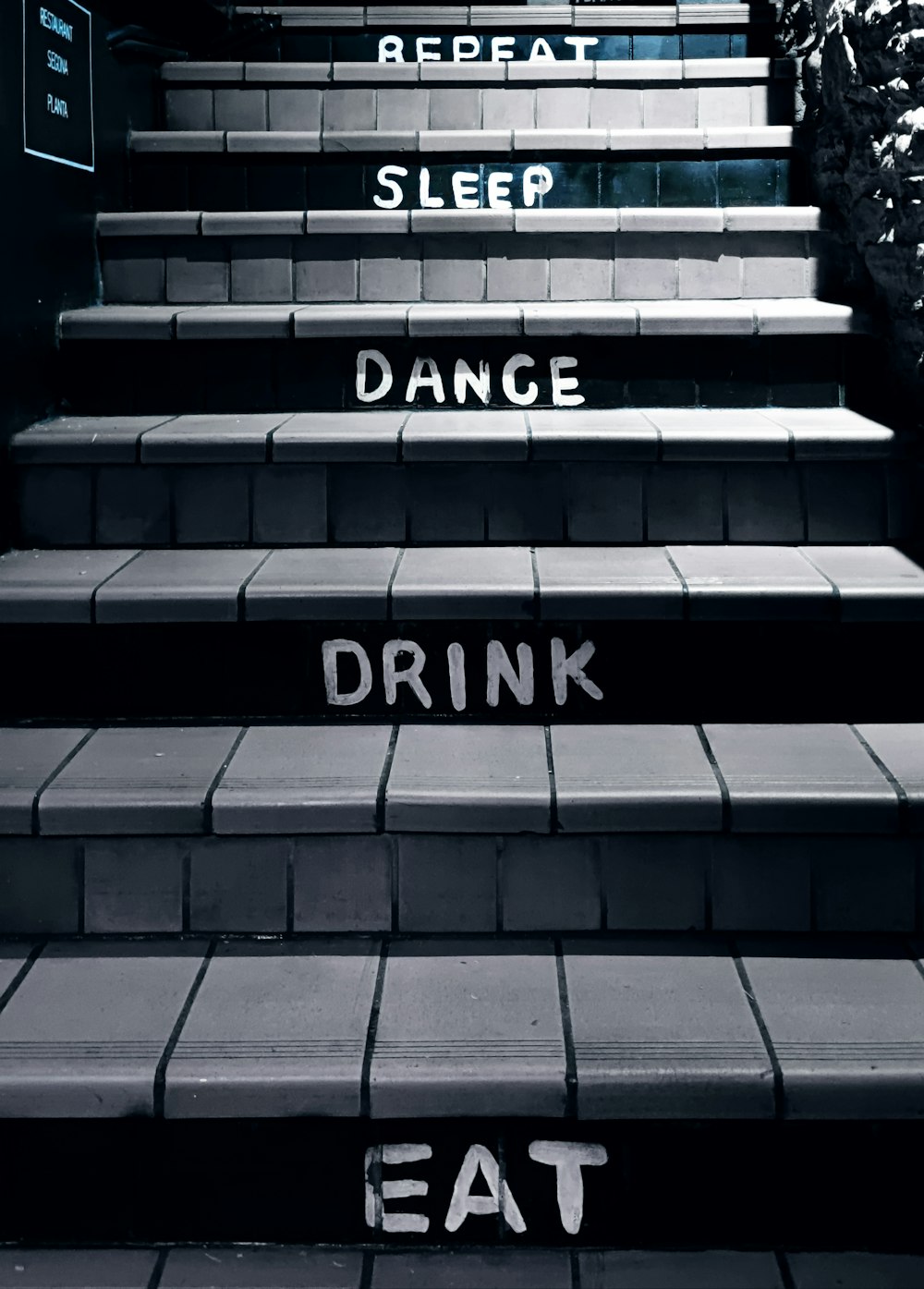 a black and white photo of a set of stairs with the words eat sleep dance