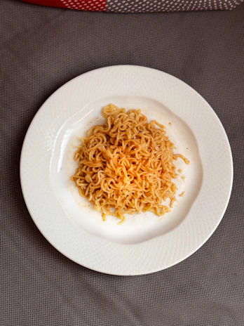 Fried sauce flavor instant noodles served in a minimalist white bowl with a subtle food-grade texture background.