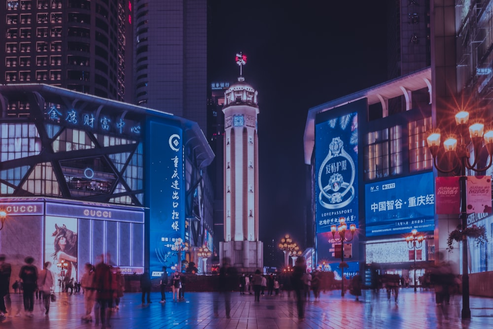 a group of people walking down a street next to tall buildings