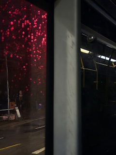 View from inside a dabaride car showing illuminated city streets with bokeh effect