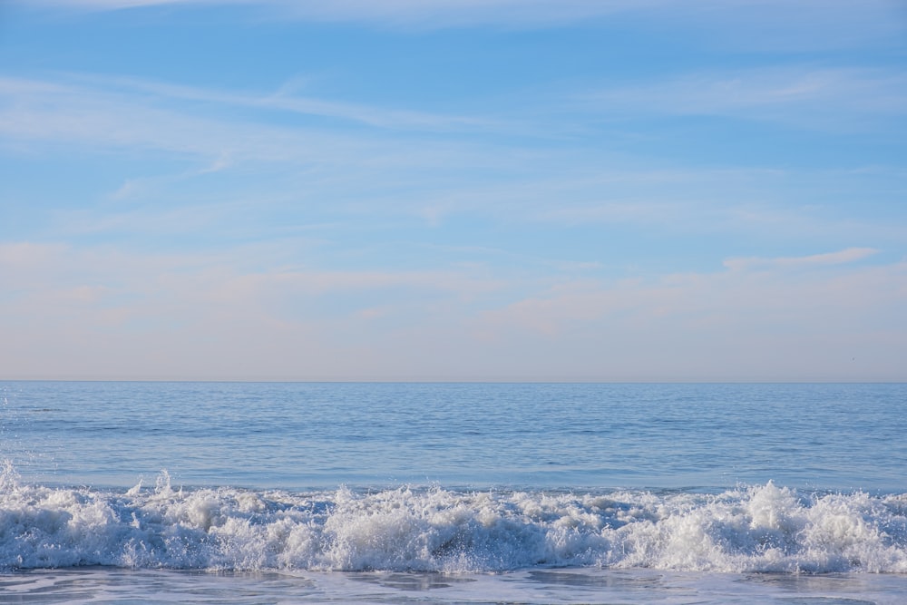 a person riding a surfboard on a wave in the ocean