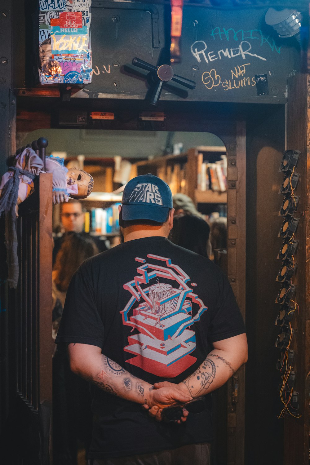 a man standing in a doorway with his back to the camera