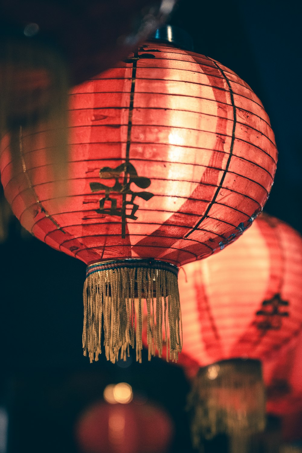 a group of red lanterns with chinese writing on them