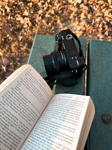 a camera and a book on a bench