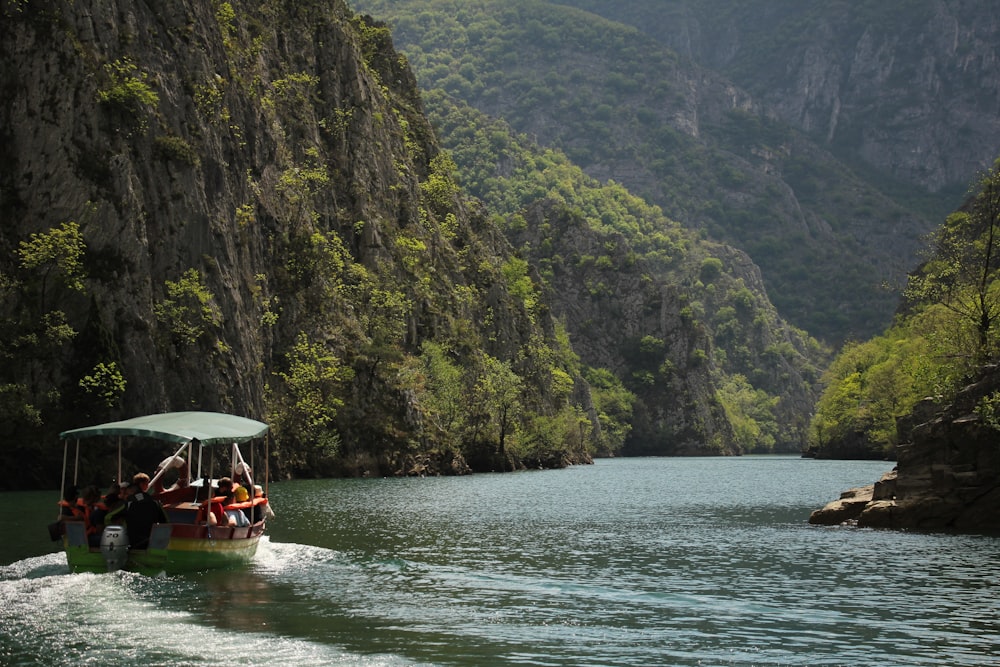 a group of people riding in a boat on a river