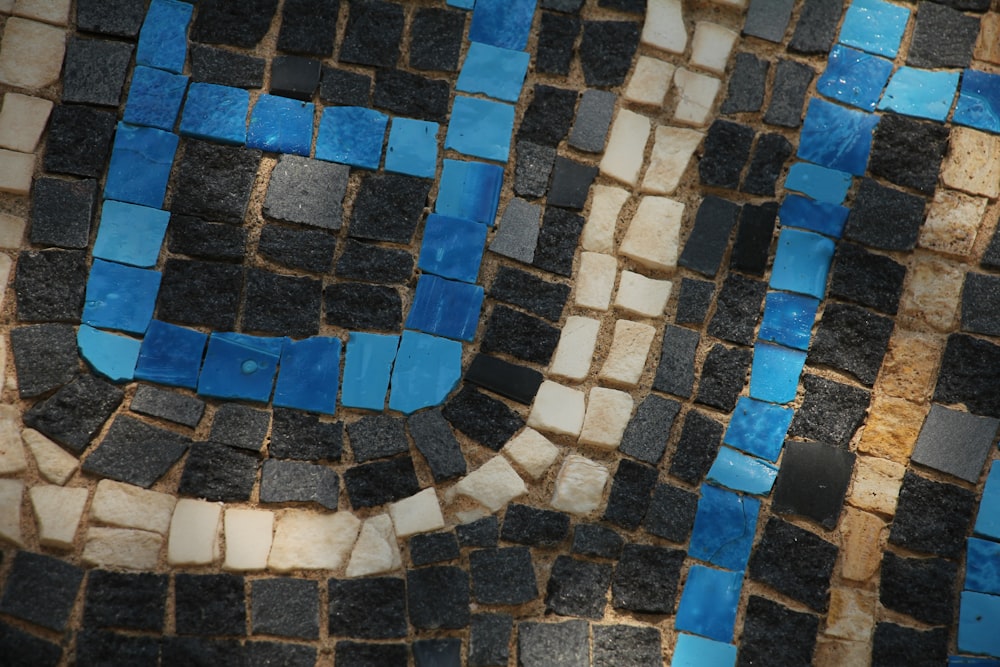 a close up of a tiled wall with blue and white tiles