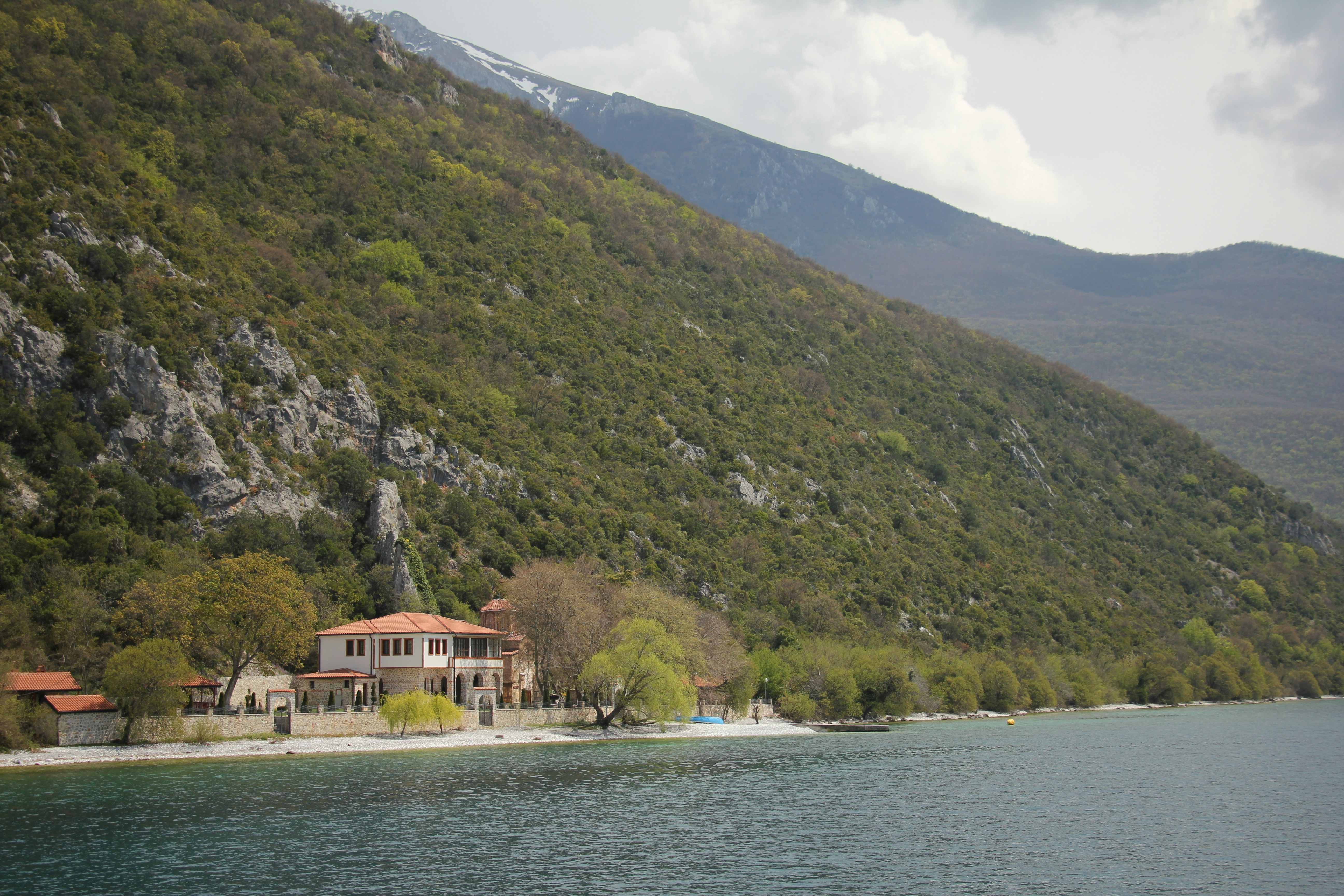 a house on the shore of a mountain lake